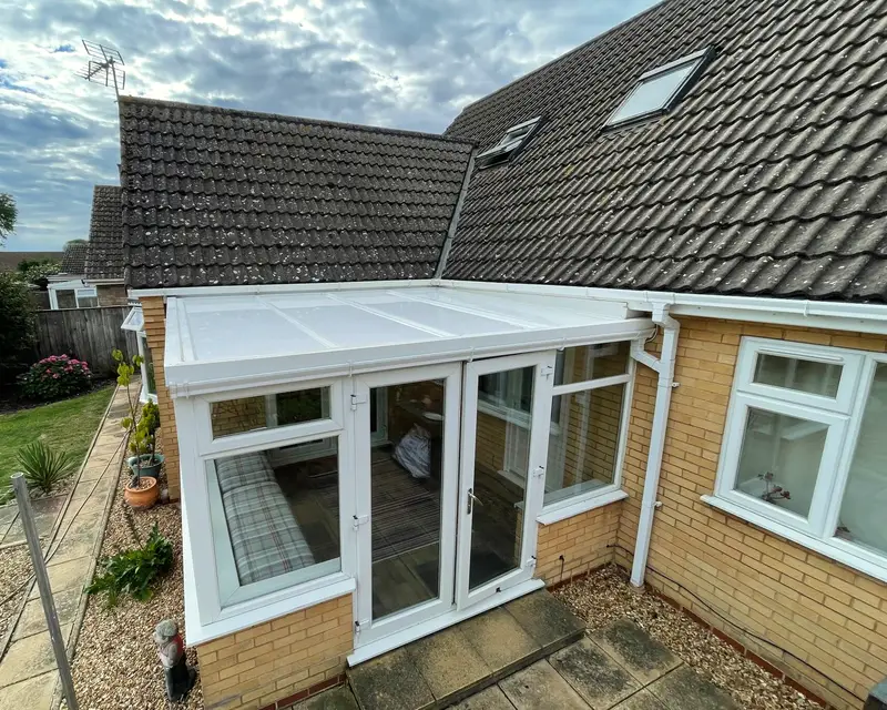 Bungalow lean-to conservatory with a white panel roof